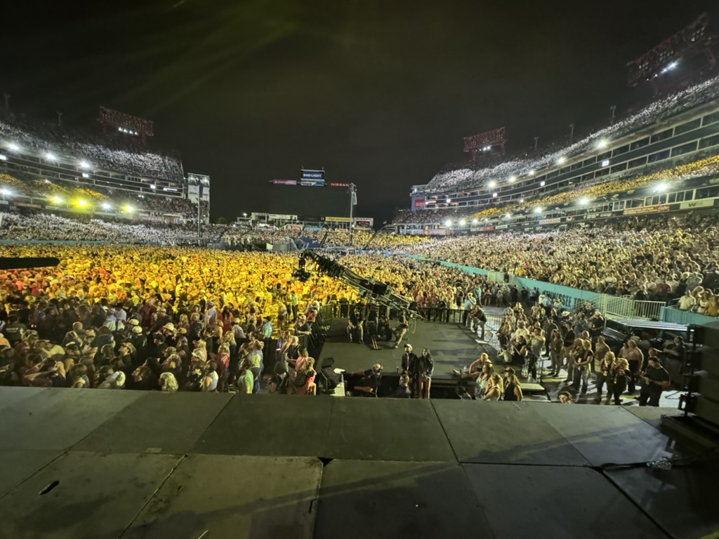 Full stadium crowd at CMA Fest Nissan Stadium main stage — view from behind the stage